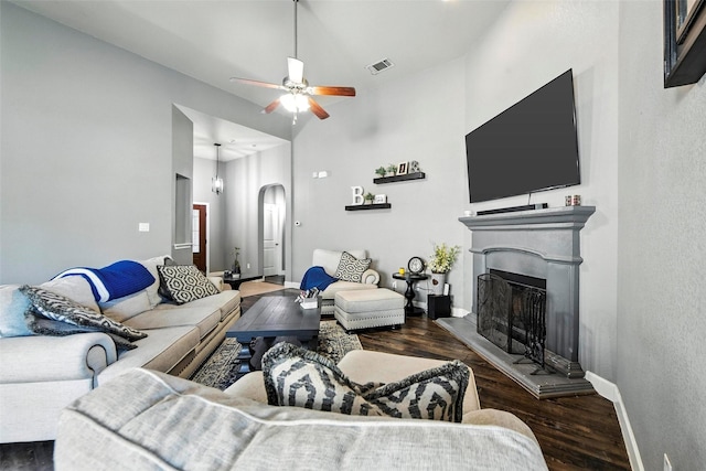 1312 Castlegar Ln, Fort Worth, TX 76247 - living area featuring wood finished floors, ceiling fan, arched walkways, and a fireplace with raised hearth