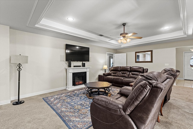 102 Southfork Cir, Pottsboro, TX 75076 - living area with a tray ceiling, light colored carpet, a ceiling fan, a glass covered fireplace, and recessed lighting