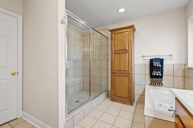 102 Southfork Cir, Pottsboro, TX 75076 - bathroom with a stall shower, tile patterned floors, a tub with jets, recessed lighting, and tile walls