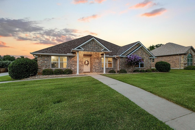 102 Southfork Cir, Pottsboro, TX 75076 - view of front facade with a front lawn, brick siding, and a shingled roof