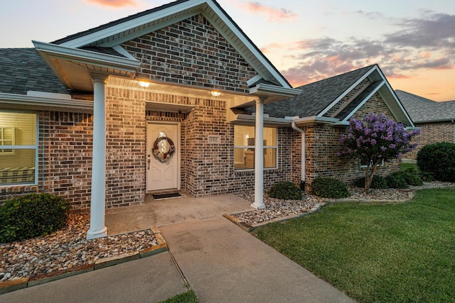 102 Southfork Cir, Pottsboro, TX 75076 - entrance to property featuring brick siding, a lawn, and a shingled roof