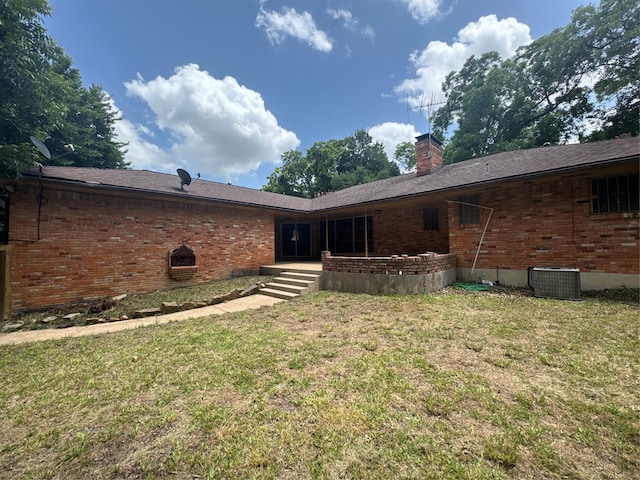 817 Brook Valley Ln, Dallas, TX 75232 - back of house featuring brick siding, a yard, and a chimney