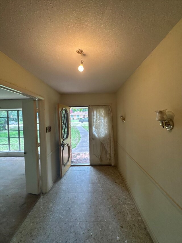 817 Brook Valley Ln, Dallas, TX 75232 - foyer featuring plenty of natural light, a textured ceiling, and tile patterned floors