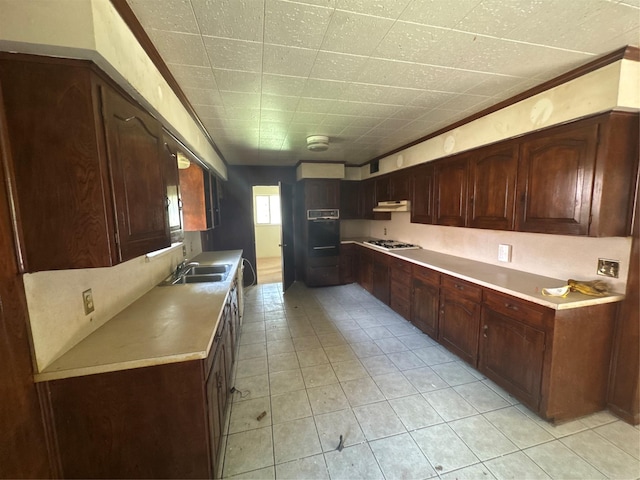 817 Brook Valley Ln, Dallas, TX 75232 - kitchen featuring under cabinet range hood, gas stovetop, light tile patterned flooring, and light countertops