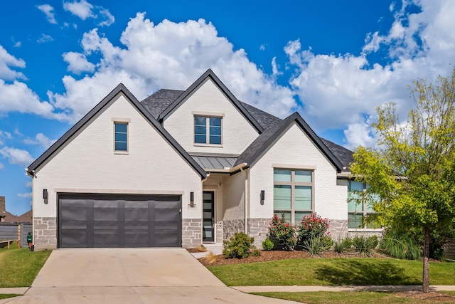7020 Union Park Blvd E, Little Elm, TX 76227 - view of front of home with stone siding, a garage, concrete driveway, a standing seam roof, and a front yard
