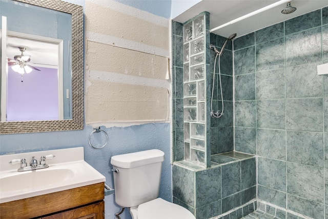4137 Salem Dr, Garland, TX 75043 - full bathroom with vanity, ceiling fan, a tile shower, and a textured wall