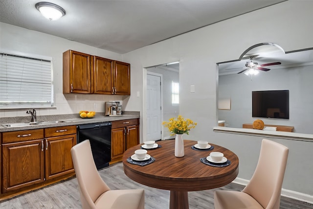 4137 Salem Dr, Garland, TX 75043 - kitchen featuring dishwasher, light wood finished floors, brown cabinets, a ceiling fan, and tasteful backsplash