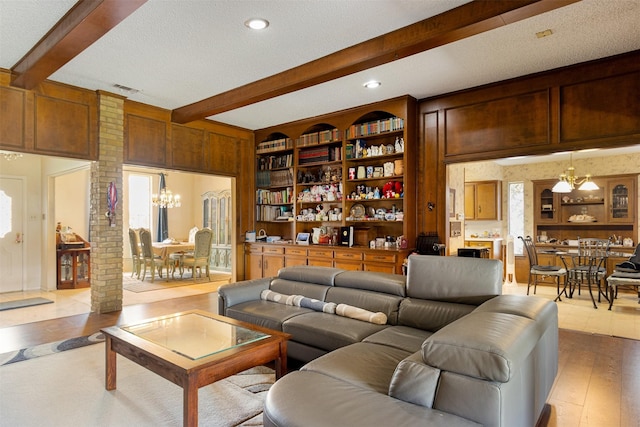 11228 Ferndale Rd, Dallas, TX 75238 - living area featuring beamed ceiling, a chandelier, wood finished floors, a textured ceiling, and recessed lighting