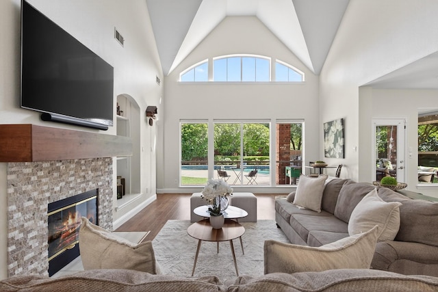 1709 Blair Ct, Carrollton, TX 75010 - living room featuring wood finished floors, a glass covered fireplace, and high vaulted ceiling
