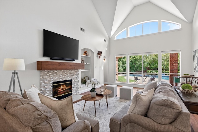 1709 Blair Ct, Carrollton, TX 75010 - living room with built in shelves, wood finished floors, a fireplace, and high vaulted ceiling