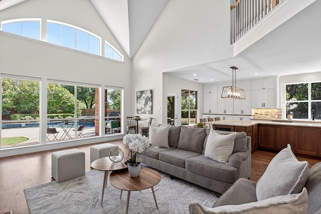 1709 Blair Ct, Carrollton, TX 75010 - living area featuring hardwood / wood-style flooring, plenty of natural light, high vaulted ceiling, a chandelier, and recessed lighting