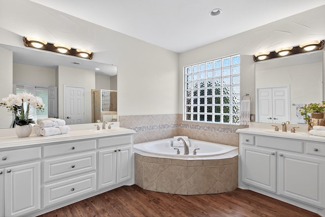 1709 Blair Ct, Carrollton, TX 75010 - full bathroom with a garden tub, vanity, wood finished floors, and a tile shower