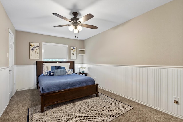 1709 Blair Ct, Carrollton, TX 75010 - carpeted bedroom with wainscoting and a ceiling fan