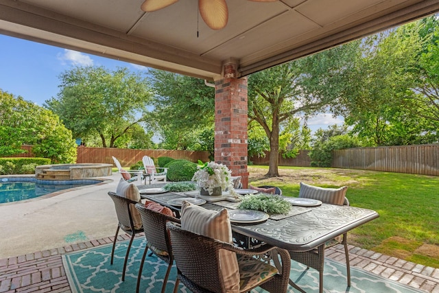 1709 Blair Ct, Carrollton, TX 75010 - fenced backyard featuring ceiling fan, outdoor dining space, a patio area, and an in-ground hot tub