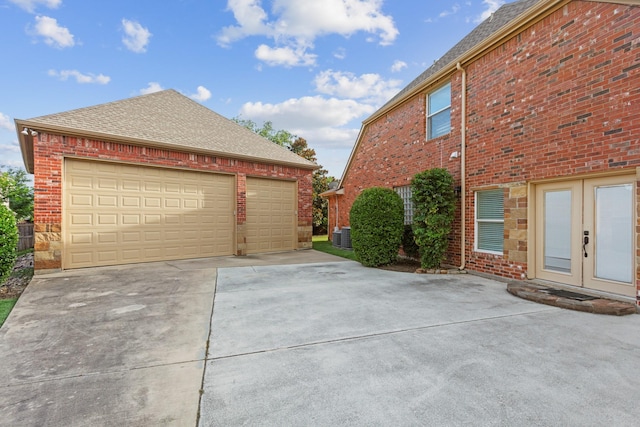 1709 Blair Ct, Carrollton, TX 75010 - view of side of home with french doors, brick siding, and roof with shingles