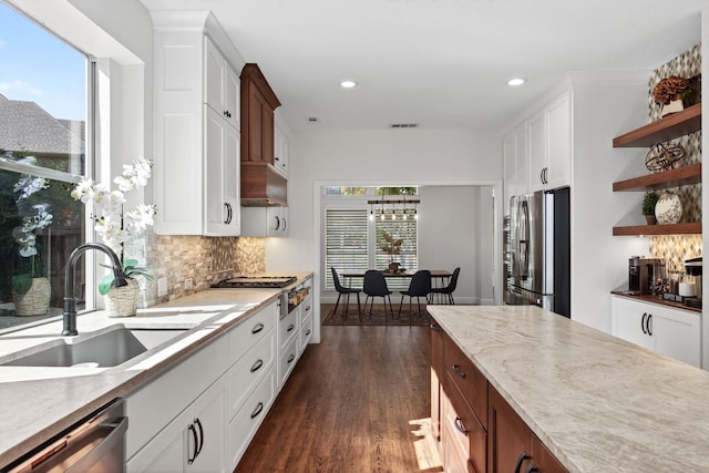 1709 Blair Ct, Carrollton, TX 75010 - kitchen featuring appliances with stainless steel finishes, open shelves, decorative backsplash, dark wood-type flooring, and white cabinets