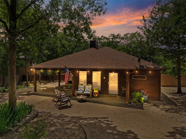 153 Bridlepath Dr, Pottsboro, TX 75076 - view of front of home with concrete driveway, a chimney, a shingled roof, a patio, and a carport