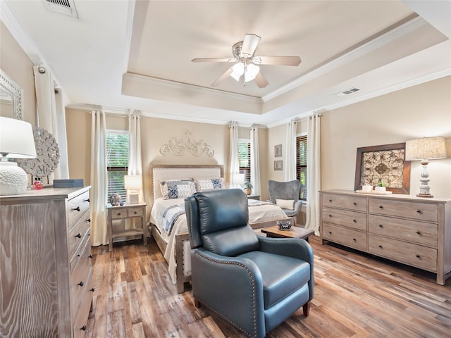 153 Bridlepath Dr, Pottsboro, TX 75076 - bedroom with a tray ceiling, light wood-type flooring, crown molding, and ceiling fan