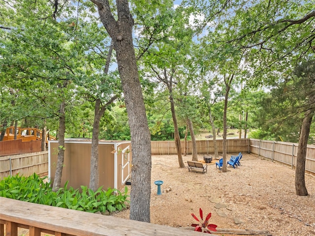 153 Bridlepath Dr, Pottsboro, TX 75076 - fenced backyard featuring a storage shed and view of scattered trees
