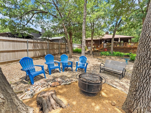 153 Bridlepath Dr, Pottsboro, TX 75076 - fenced backyard with an outdoor fire pit and a wooden deck