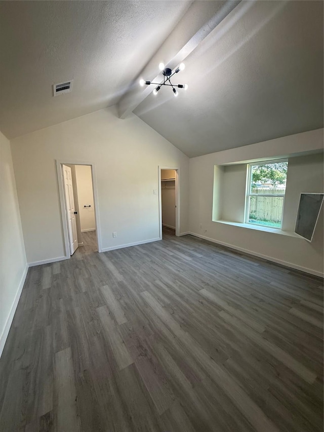 2703 Hollow Bnd, Mesquite, TX 75150 - unfurnished living room featuring dark wood-type flooring, a chandelier, and a textured ceiling