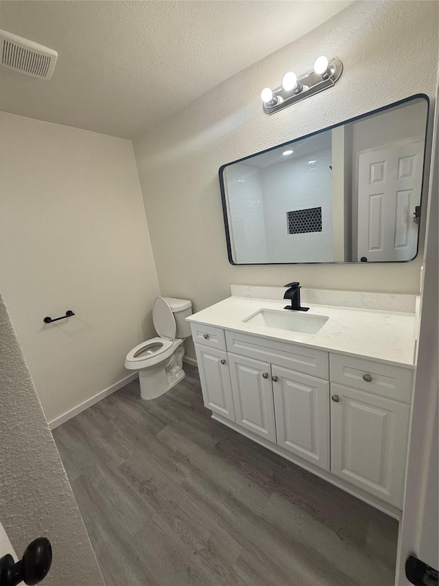 2703 Hollow Bnd, Mesquite, TX 75150 - bathroom featuring vanity, wood finished floors, and a textured ceiling