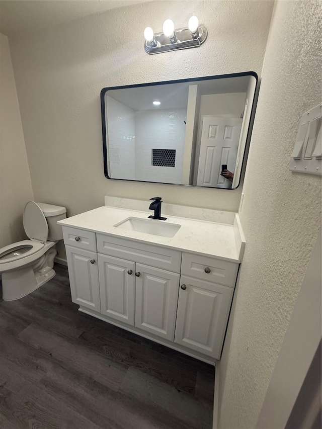 2703 Hollow Bnd, Mesquite, TX 75150 - bathroom with wood finished floors, vanity, and a textured wall