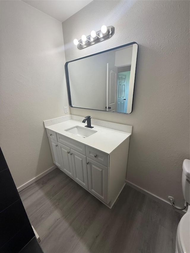 2703 Hollow Bnd, Mesquite, TX 75150 - half bathroom with vanity and wood finished floors