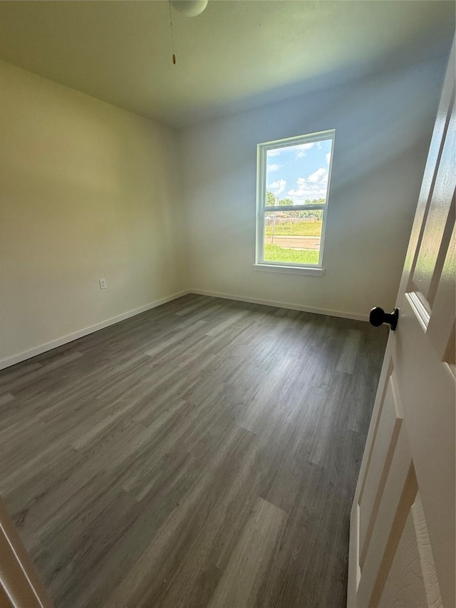 2703 Hollow Bnd, Mesquite, TX 75150 - spare room featuring dark wood-type flooring and baseboards