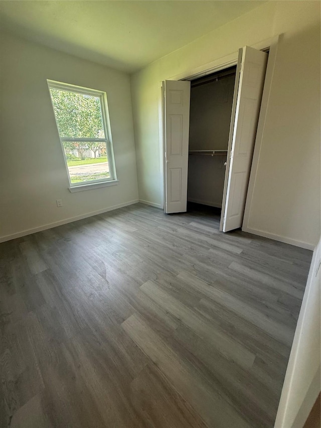 2703 Hollow Bnd, Mesquite, TX 75150 - unfurnished bedroom with wood finished floors and a closet