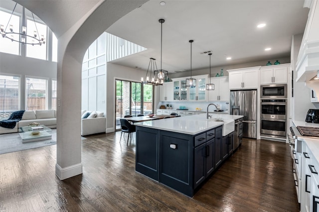 840 Redstem Dr, Prosper, TX 75078 - kitchen featuring stainless steel appliances, a chandelier, white cabinets, light countertops, and glass insert cabinets