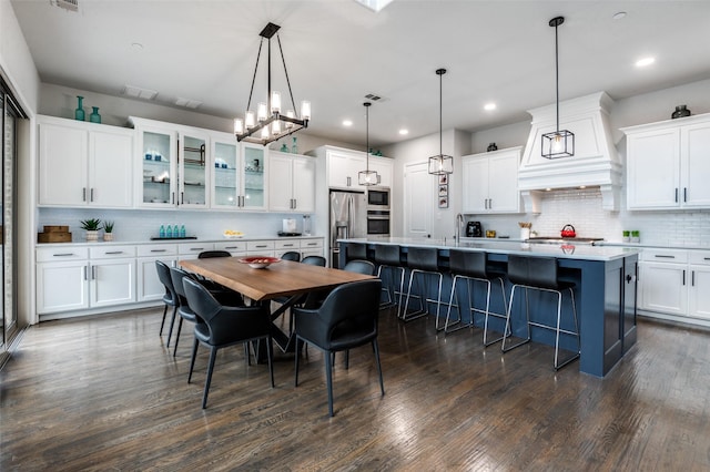 840 Redstem Dr, Prosper, TX 75078 - kitchen featuring appliances with stainless steel finishes, tasteful backsplash, an island with sink, white cabinetry, and recessed lighting