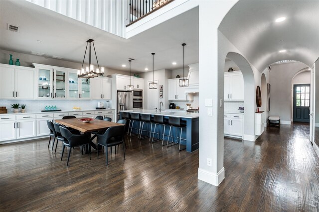 840 Redstem Dr, Prosper, TX 75078 - dining space with recessed lighting, dark wood finished floors, high vaulted ceiling, and arched walkways
