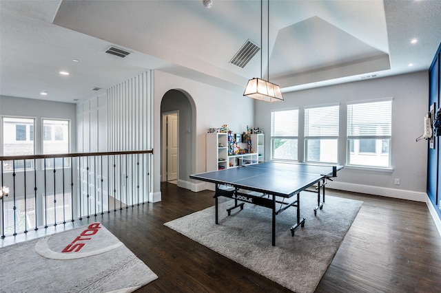 840 Redstem Dr, Prosper, TX 75078 - playroom with arched walkways, dark wood-style flooring, recessed lighting, and a tray ceiling