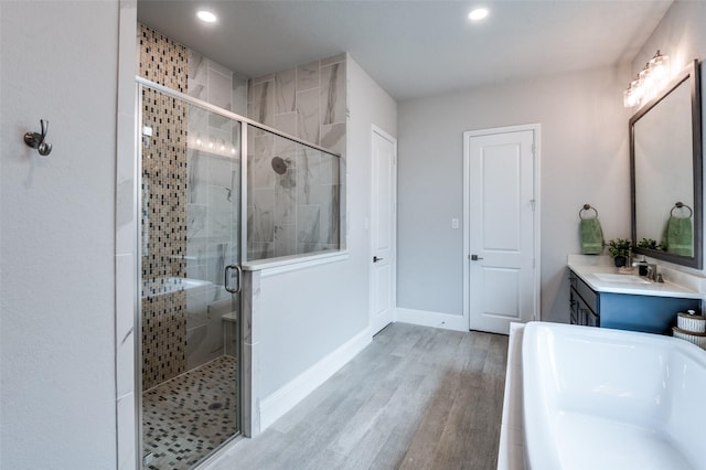 840 Redstem Dr, Prosper, TX 75078 - bathroom featuring a bath, vanity, a stall shower, wood finished floors, and recessed lighting