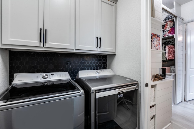 840 Redstem Dr, Prosper, TX 75078 - laundry room featuring washing machine and dryer, cabinet space, a textured wall, and light wood finished floors