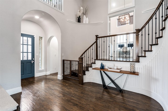 840 Redstem Dr, Prosper, TX 75078 - foyer entrance featuring wood finished floors, stairway, a chandelier, arched walkways, and a towering ceiling