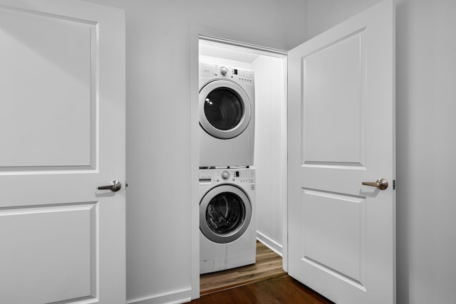 1200 Main St Unit 707, Dallas, TX 75202 - laundry room featuring stacked washing machine and dryer and dark wood-style flooring