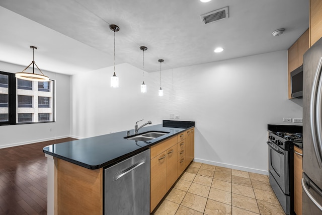 1200 Main St Unit 707, Dallas, TX 75202 - kitchen with appliances with stainless steel finishes, a peninsula, dark countertops, pendant lighting, and recessed lighting