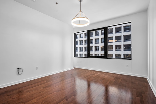 1200 Main St Unit 707, Dallas, TX 75202 - spare room featuring dark wood finished floors and a pendent fire sprinkler