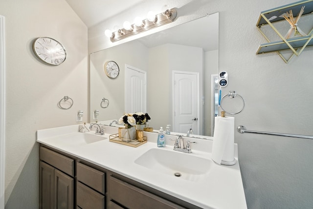 9117 Blakely Dr, Fort Worth, TX 76134 - bathroom featuring double vanity and vaulted ceiling