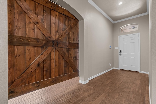 842 Randall Rd, Weatherford, TX 76087 - foyer featuring crown molding, arched walkways, and wood finished floors