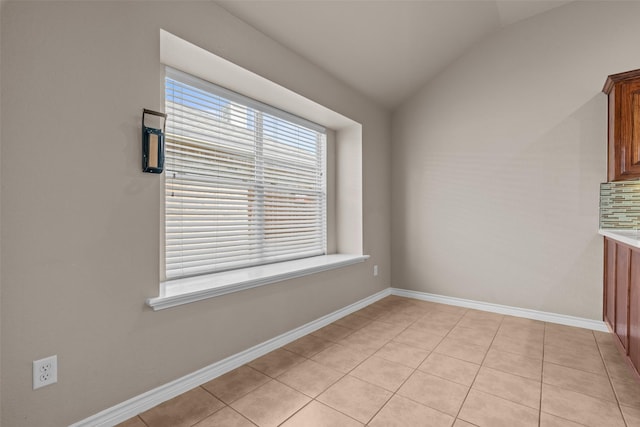 842 Randall Rd, Weatherford, TX 76087 - unfurnished dining area with vaulted ceiling and light tile patterned flooring