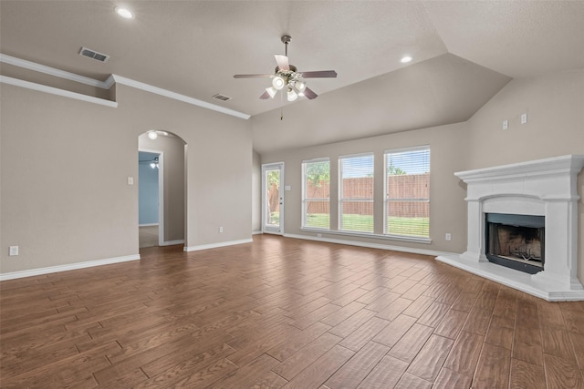 842 Randall Rd, Weatherford, TX 76087 - unfurnished living room with a ceiling fan, wood finished floors, arched walkways, a fireplace with raised hearth, and recessed lighting