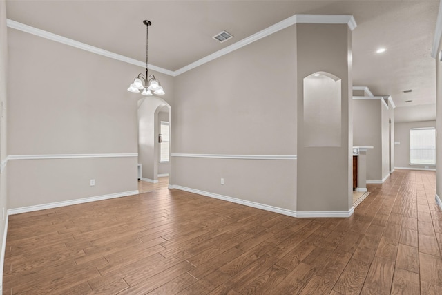 842 Randall Rd, Weatherford, TX 76087 - unfurnished room with arched walkways, wood finished floors, and crown molding