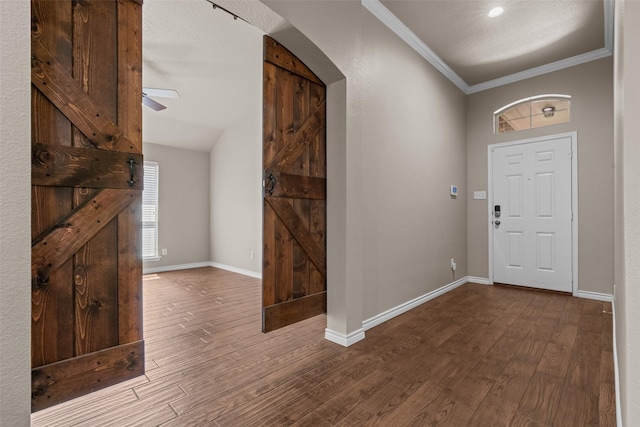 842 Randall Rd, Weatherford, TX 76087 - entryway featuring arched walkways, ornamental molding, wood finished floors, and a ceiling fan