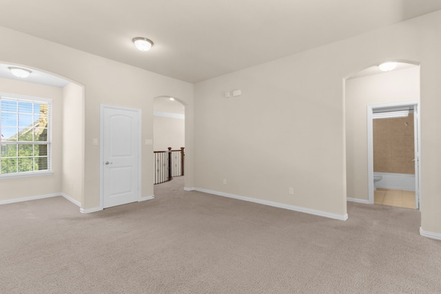 4560 Cheetah Trl, Frisco, TX 75034 - empty room with arched walkways and light colored carpet