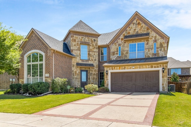 4560 Cheetah Trl, Frisco, TX 75034 - french country inspired facade featuring stone siding, concrete driveway, an attached garage, brick siding, and a standing seam roof