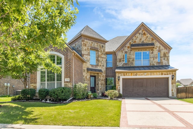 4560 Cheetah Trl, Frisco, TX 75034 - view of front of home with stone siding, driveway, an attached garage, and brick siding