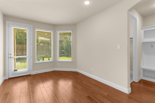 4560 Cheetah Trl, Frisco, TX 75034 - empty room featuring wood finished floors, arched walkways, and recessed lighting